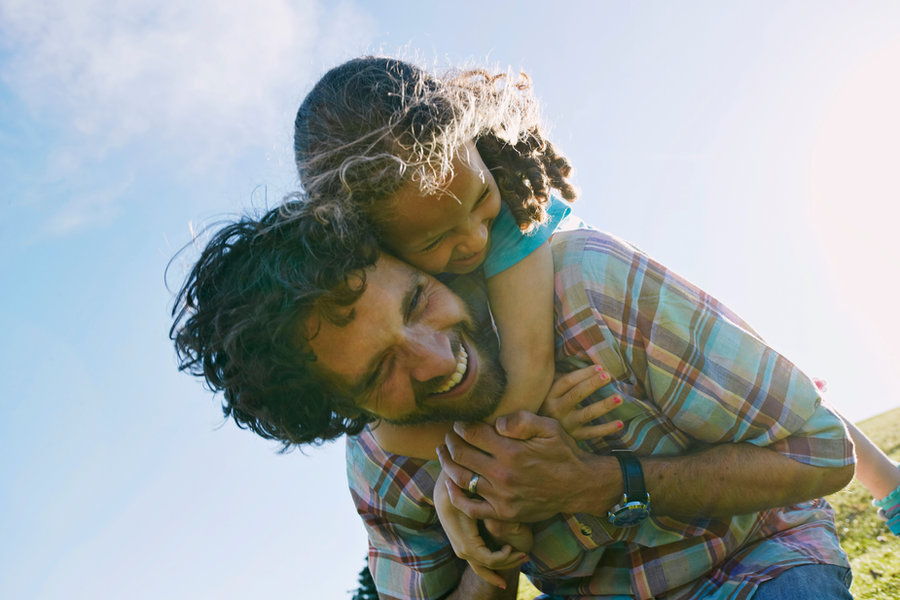 Father carrying child outdoors