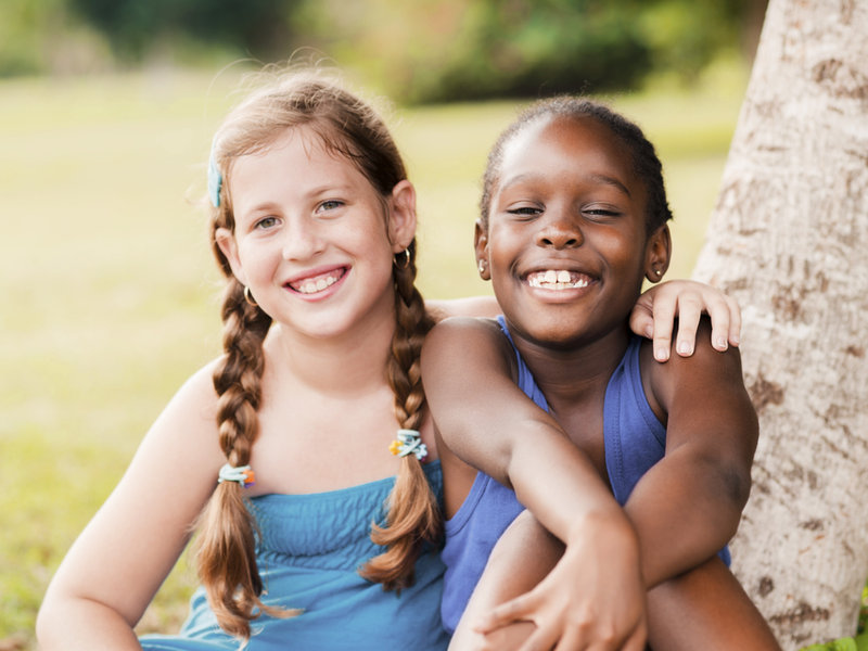 Two happy girls smiling together