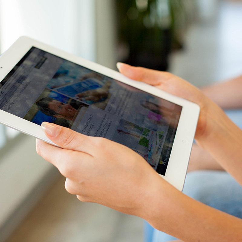 Parent viewing a secure live stream of the session on a tablet